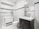 Elegant bathroom features white marble walls, glass shelving, and updated fixtures at 109 Barcliff Ter, Cary, NC 27518