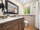 Updated bathroom with a wooden vanity, quartz countertops, mosaic tile accents, and a window view at 109 Barcliff Ter, Cary, NC 27518