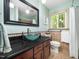 Stylish bathroom features a unique glass bowl sink, and ample storage space at 109 Barcliff Ter, Cary, NC 27518