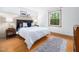 Comfortable bedroom features hardwood floors, ample natural light, and tranquil decor at 109 Barcliff Ter, Cary, NC 27518