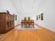 Bright dining room with hardwood floors, large windows, and a neutral rug under the dining table for six at 109 Barcliff Ter, Cary, NC 27518