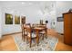 Bright dining room with a high ceiling, large windows, skylights, and a wood dining table with seating for six at 109 Barcliff Ter, Cary, NC 27518