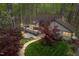 Scenic exterior view showcasing a charming home with a spacious deck and beautifully landscaped yard with a stone pathway at 109 Barcliff Ter, Cary, NC 27518
