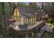 Stunning exterior featuring a large deck perfect for outdoor dining and relaxation surrounded by a lush forest setting at 109 Barcliff Ter, Cary, NC 27518