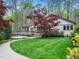 Charming exterior with a lush green lawn, stone pathway, and beautiful landscaping surrounding the house at 109 Barcliff Ter, Cary, NC 27518