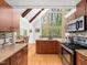 Open kitchen features granite counters, stainless appliances, and a large window with wooded views at 109 Barcliff Ter, Cary, NC 27518