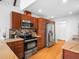 Well-equipped kitchen featuring stainless appliances, granite counters, and ample wood cabinetry at 109 Barcliff Ter, Cary, NC 27518