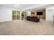 Spacious living room with recessed lighting, neutral carpet, and sliding glass doors to a deck at 109 Barcliff Ter, Cary, NC 27518