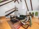 Open-concept living room with striking wooden beams, bamboo floors and an open staircase to the upper level at 109 Barcliff Ter, Cary, NC 27518