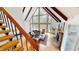 Open-concept living room with vaulted ceilings, large windows, wood floors, and a cozy fireplace perfect for gatherings at 109 Barcliff Ter, Cary, NC 27518