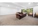 Spacious living room area with recessed lighting, neutral carpet, and sliding glass doors to the backyard at 109 Barcliff Ter, Cary, NC 27518