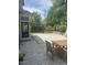Cozy backyard patio featuring a stone surface, outdoor dining area, and basketball hoop at 113 Bennett Mountain Trce, Chapel Hill, NC 27516