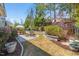 Well-maintained backyard with patio, dining set, fire pit and lush landscaping, perfect for outdoor living at 113 Bennett Mountain Trce, Chapel Hill, NC 27516