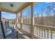 Covered balcony with rocking chairs and scenic views of the surrounding landscape at 113 Bennett Mountain Trce, Chapel Hill, NC 27516