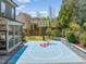 Outdoor basketball court and backyard with screened porch, perfect for recreation and relaxation at 113 Bennett Mountain Trce, Chapel Hill, NC 27516