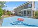 Backyard featuring outdoor dining, screened porch, and a vibrant blue basketball court with a Hoosiers logo at 113 Bennett Mountain Trce, Chapel Hill, NC 27516