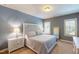 Well-lit bedroom with a white decorative headboard and two windows providing natural light at 113 Bennett Mountain Trce, Chapel Hill, NC 27516