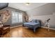 Cozy bedroom with a basketball theme, hardwood floors, and ample natural light at 113 Bennett Mountain Trce, Chapel Hill, NC 27516