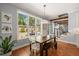 Bright dining area featuring large windows, a wooden table, and view of landscaped backyard at 113 Bennett Mountain Trce, Chapel Hill, NC 27516