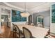 Dining room featuring an elegant chandelier and designer wallpaper and doorway to kitchen at 113 Bennett Mountain Trce, Chapel Hill, NC 27516