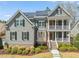 Two-story home with gray siding, solar panels, black shutters, and manicured landscaping at 113 Bennett Mountain Trce, Chapel Hill, NC 27516