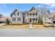 Attractive two-story home featuring a welcoming front porch, well-manicured lawn, and classic architectural details at 113 Bennett Mountain Trce, Chapel Hill, NC 27516
