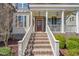 Stairs lead up to a covered porch with white columns and a bright red front door at 113 Bennett Mountain Trce, Chapel Hill, NC 27516