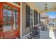 Inviting front porch with rocking chairs and a red front door with glass panels at 113 Bennett Mountain Trce, Chapel Hill, NC 27516