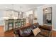 Bright kitchen featuring white cabinets, stainless steel appliances, pendant lighting and bar stool seating at 113 Bennett Mountain Trce, Chapel Hill, NC 27516