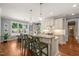 Eat-in kitchen featuring an island with barstool seating, and an adjacent dining area with large windows at 113 Bennett Mountain Trce, Chapel Hill, NC 27516
