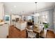 Open-concept kitchen featuring granite countertops, stainless appliances, and a dining area at 113 Bennett Mountain Trce, Chapel Hill, NC 27516