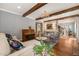 Elegant living room featuring hardwood floors, wooden beams, and a decorative chandelier at 113 Bennett Mountain Trce, Chapel Hill, NC 27516
