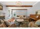 Comfortable living room with wood beams, fireplace, and a piano at 113 Bennett Mountain Trce, Chapel Hill, NC 27516