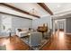 Living room with hardwood floors, wood beams, fireplace, and a piano at 113 Bennett Mountain Trce, Chapel Hill, NC 27516