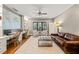 Inviting living room with a ceiling fan, a built-in desk, and a plush leather sofa at 113 Bennett Mountain Trce, Chapel Hill, NC 27516
