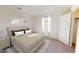 Comfortable bedroom with neutral tones, soft carpet, and a window for natural light at 1169 Solace Way, Rolesville, NC 27571