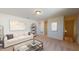 Cozy living room featuring neutral tones, a comfortable sofa, and stylish decor at 1169 Solace Way, Rolesville, NC 27571