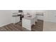 Bright kitchen with stainless appliances, gray granite counters and white cabinets at 1173 Solace Way, Rolesville, NC 27571