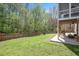 Spacious backyard featuring a lush lawn, wooden fence, and a covered patio area at 118 Benedum Pl, Cary, NC 27518