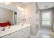 Bathroom featuring double sinks and a large mirror at 118 Benedum Pl, Cary, NC 27518