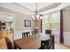 Cozy dining room with a large window, stylish chandelier, and inviting atmosphere at 118 Benedum Pl, Cary, NC 27518