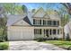 Inviting two-story home with black shutters, white siding, and a well-manicured front lawn at 118 Benedum Pl, Cary, NC 27518