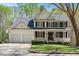 Charming two-story traditional home featuring a welcoming front porch and attached two car garage at 118 Benedum Pl, Cary, NC 27518