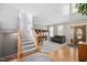 Inviting foyer with staircase, hardwood floors, and natural light, leading to a cozy living space at 118 Benedum Pl, Cary, NC 27518