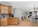 Open kitchen view with granite countertops, wooden cabinets, and seamless transition to the living area at 118 Benedum Pl, Cary, NC 27518