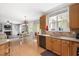 Bright, updated kitchen with wood cabinets, modern appliances, and a view to the backyard at 118 Benedum Pl, Cary, NC 27518