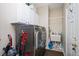 Efficient laundry room with washer, dryer, utility sink, and ample storage cabinets at 118 Benedum Pl, Cary, NC 27518