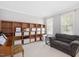 Cozy living room featuring built-in bookshelves, a comfortable sofa, and natural light from large windows at 118 Benedum Pl, Cary, NC 27518