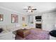Comfortable living room featuring a fireplace, built-in shelves, and stylish furnishings at 118 Benedum Pl, Cary, NC 27518