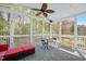 Relaxing screened porch featuring a ceiling fan and views of a lush backyard at 118 Benedum Pl, Cary, NC 27518